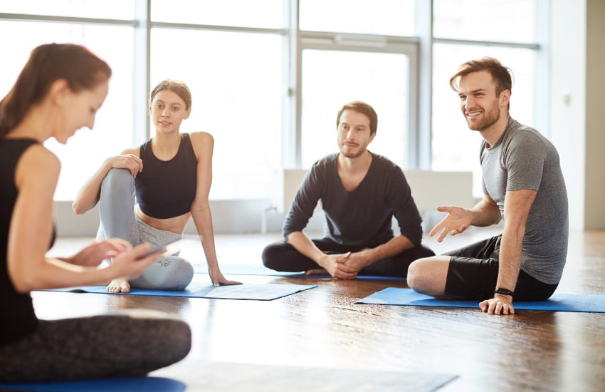 How Much Should I Charge For a Yoga Class: Striking the Perfect Pose Between Value and Affordability 3 woman commuication with students