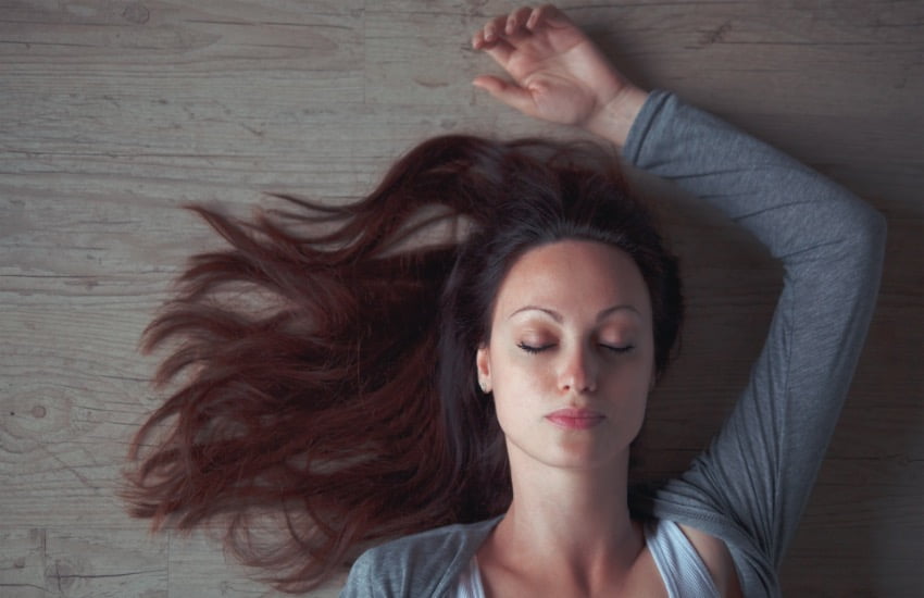 What are the Benefits of Guided Meditation? Turns out A lot! 3 woman-relaxed-laying-down-on-the-ground-w-eyes-closed